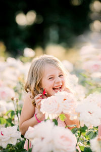 Portrait of smiling girl with pink flower