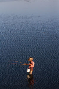 High angle view of man fishing in the sea