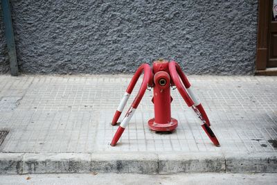 Red fire hydrant on footpath