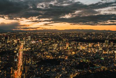 High angle view of illuminated cityscape against sky during sunset