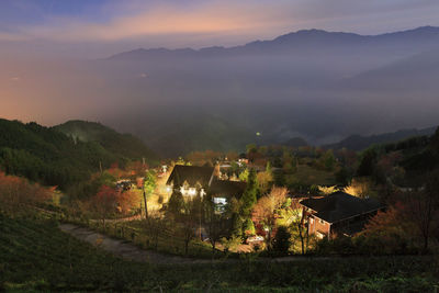 Scenic view of mountains and houses against sky