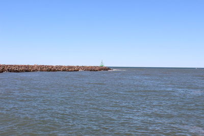 Scenic view of sea against clear blue sky