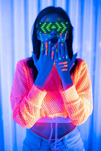 Midsection of woman holding illuminated lighting equipment