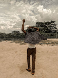 Rear view of woman standing on ground