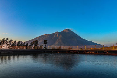 Scenic view of mountain against blue sky