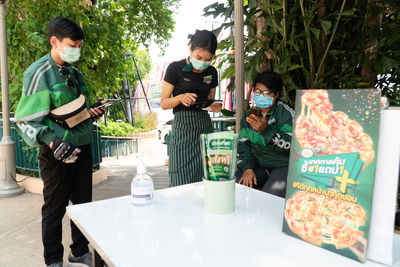 Rear view of people holding food