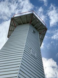 Low angle view of timber lighthouse against sky