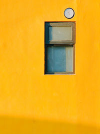 Full frame shot of yellow window on orange wall