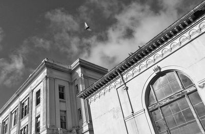 Low angle view of building against cloudy sky