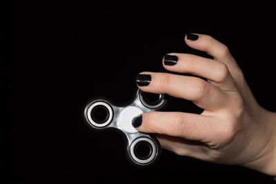 Close-up of woman hand against black background