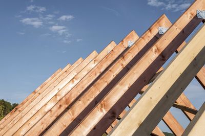 Low angle view of wooden structure against blue sky