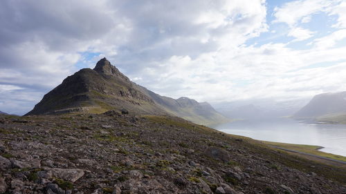 Scenic view of mountains against cloudy sky