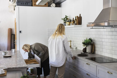 Female friends in kitchen