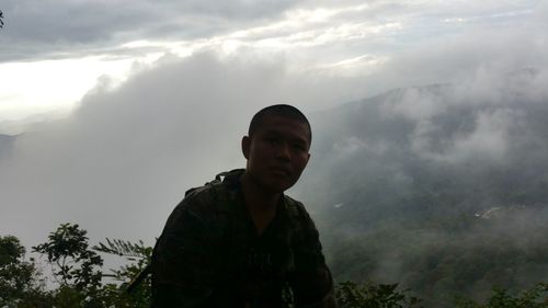 Man standing on mountain against sky