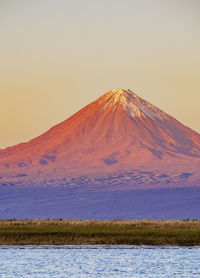 Scenic view of snowcapped mountain against sky during sunset