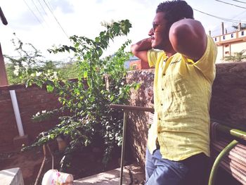 Side view of man sitting outdoors