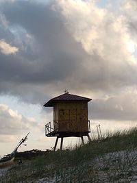 Abandoned hut on land against sky