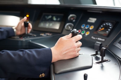 Close-up of man using mobile phone in bus