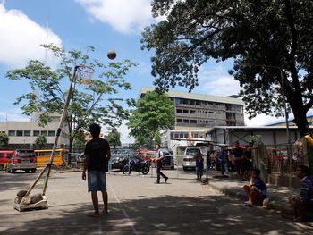 People in city against sky