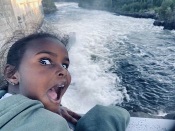 Portrait of boy looking at sea