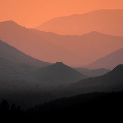 Scenic view of silhouette mountains against sky during sunset