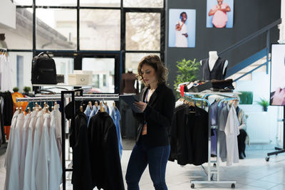 Portrait of smiling young woman standing in store