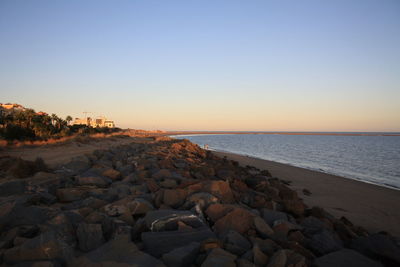 Scenic view of sea against clear sky during sunset