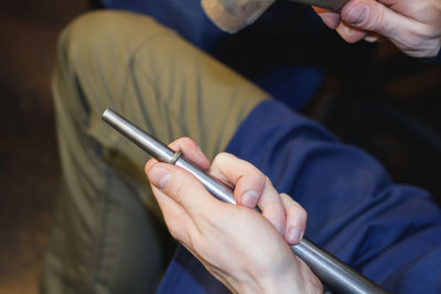 Cropped hands of man holding hand tool