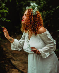 Midsection of woman standing by tree