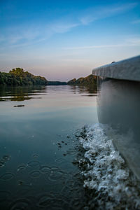 Scenic view of lake against sky at sunset