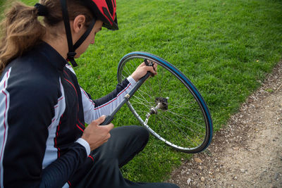 High angle view of athlete repairing tire