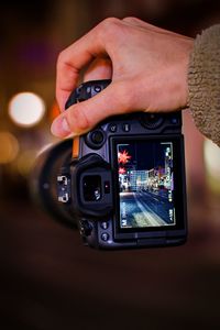 Cropped hand holding camera