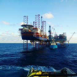 Commercial dock by sea against sky