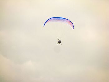 Low angle view of powered paragliding against sky