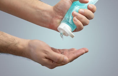 Close-up of hand holding bottle