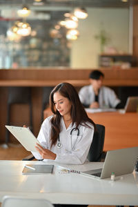 Doctor examining medical record at hospital