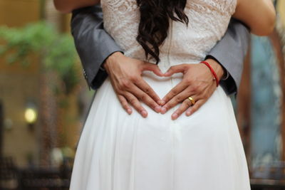 Midsection of couple dancing during wedding