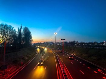 Light trails on highway against sky in city