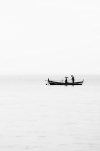 Black and white shot of fisherman in the sea 