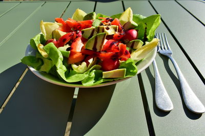 High angle view of chopped fruits in plate on table