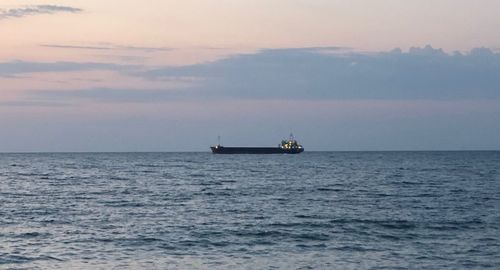 Boat sailing in sea against sky