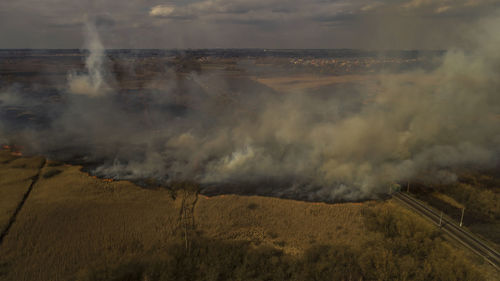 Massive fire, dry grass lanes in fire, firefighters at work, disaster, ecological catastrophe