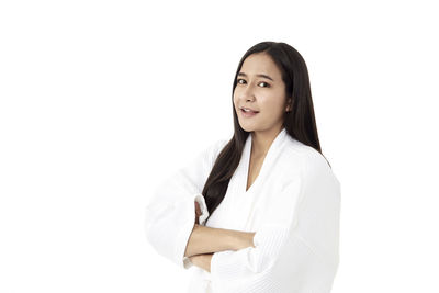 Portrait of a smiling young woman over white background