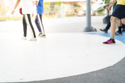 Low section of people walking on street