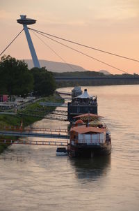 High angle view of ferry boats moored on river at sunset