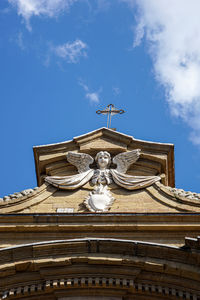 Low angle view of statue of building against sky