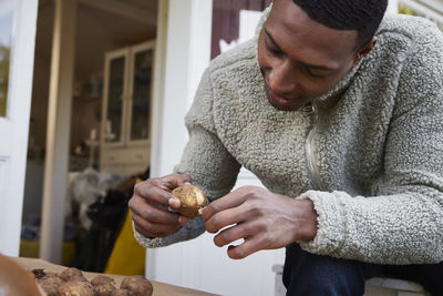 Man holding fresh potato