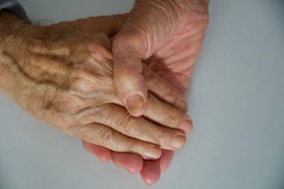 Close-up of woman hand over white background