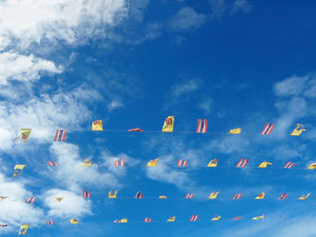 Low angle view of bunting flags against sky