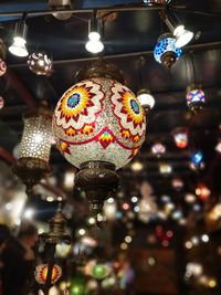 Low angle view of illuminated lanterns hanging in store